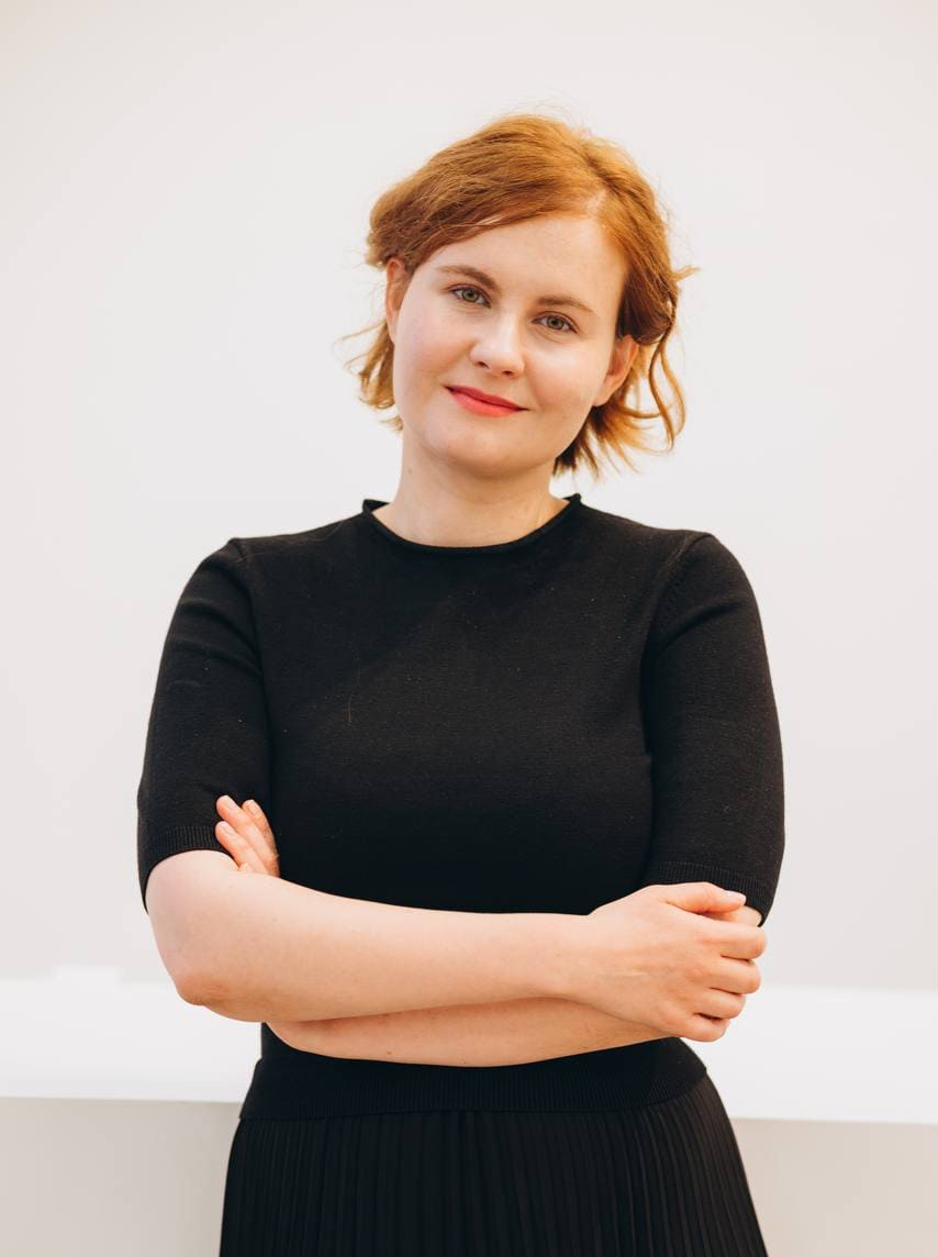 Valeriia Palii — Ukrainian clinical psychologist standing outdoors near greenery
