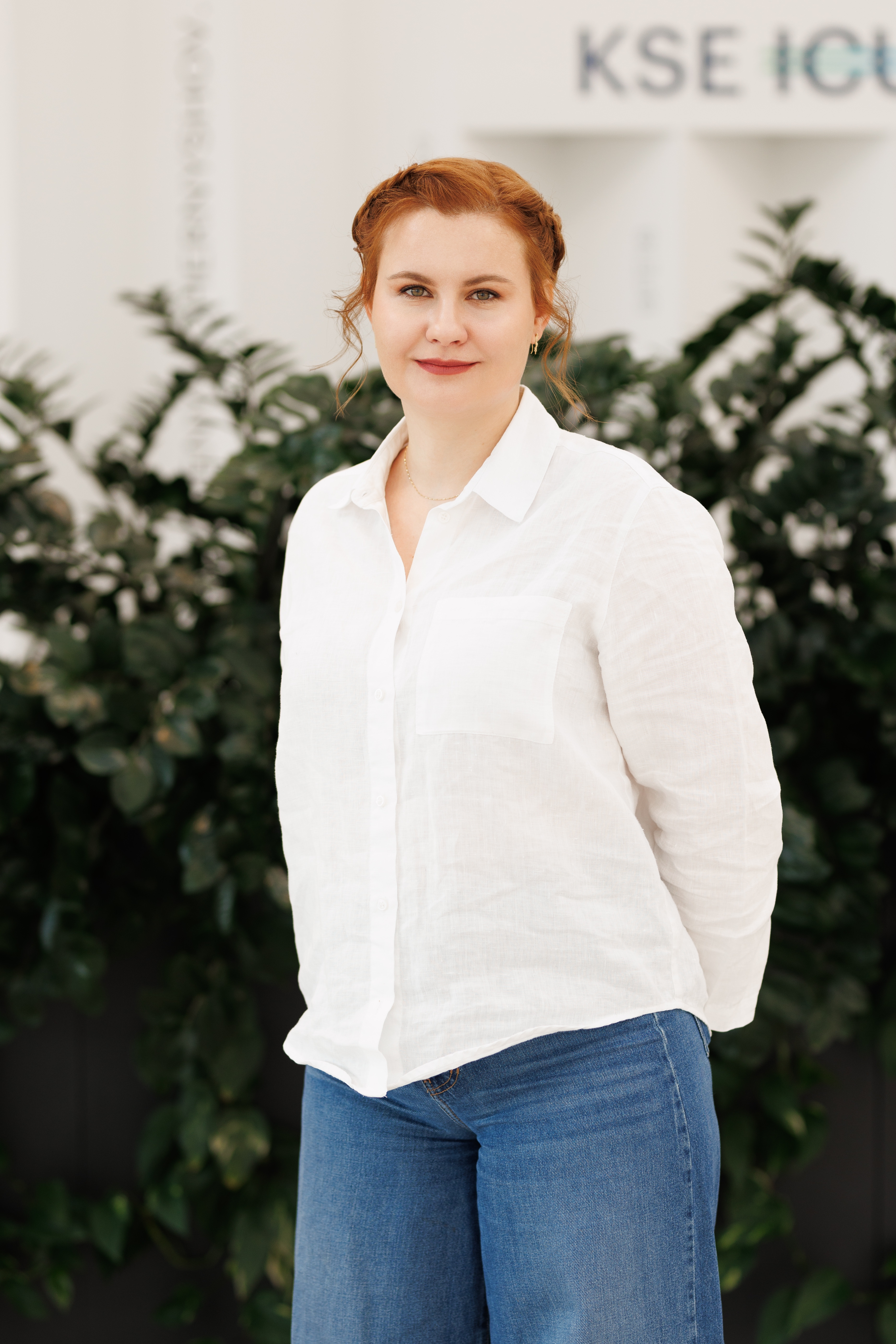 Valeriia Palii — Ukrainian clinical psychologist standing outdoors near greenery
